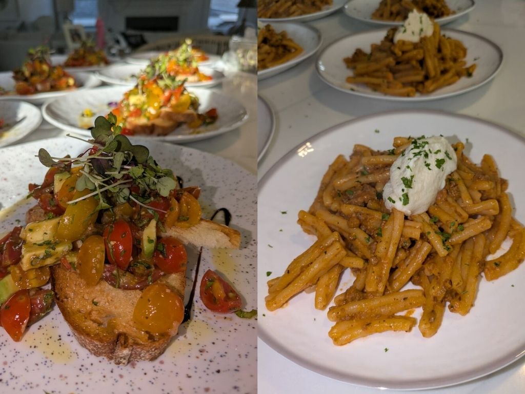 The image shows two dishes on separate plates. The left has bruschetta topped with cherry tomatoes and herbs; the right features pasta with cream and parsley.